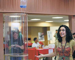 Janelle Russell of Youngstown, who is pursuing a master’s degree in chemistry at Youngstown State University, watches as her plastic bag floats to the top of the wind tunnel at YSU’s Geek Fest. The event was planned to bring attention to Science, Technology, Engineering and Math programs.