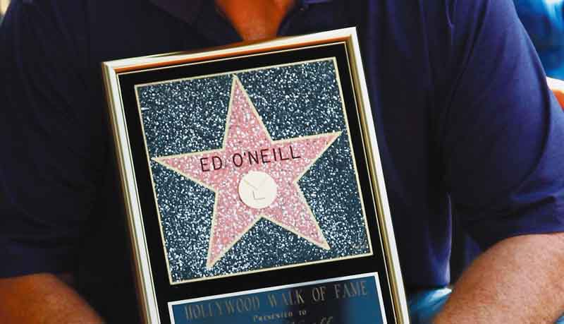 Actor Ed O'Neill poses for photographers after receiving a star of the Hollywood Walk of Fame in Los Angeles, Tuesday, Aug. 30, 2011.  O'Neill currently stars on the television show "Modern Family". (AP Photo/Matt Sayles)