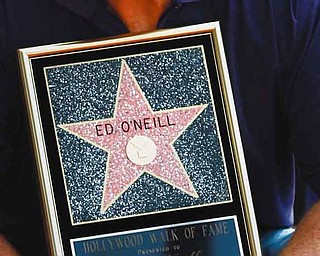 Actor Ed O'Neill poses for photographers after receiving a star of the Hollywood Walk of Fame in Los Angeles, Tuesday, Aug. 30, 2011. O'Neill currently stars on the television show "Modern Family". (AP Photo/Matt Sayles)