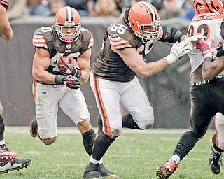 Cleveland Browns running back Peyton Hillis (40) follows a block by guard Eric Steinbach (65) against the Cincinnati Bengals in their NFL football game on Sunday, Oct. 3, 2010, in Cleveland.  (AP Photo/Amy Sancetta)