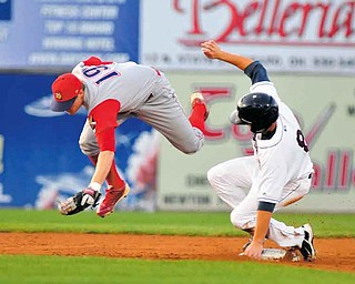 Scrappers base runner #8 Todd Hankins slides in safly to second while Crosscutters second basemen leaps to field the ball.