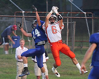 FOOTBALL - (6) Kenny Pozega battles Jake Pishotti for the ball during thier game Thursday night in Cortland. - Special to The Vindicator/Nick Mays