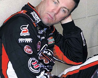 FILE - In this Aug. 19, 2011 file phot, Kevin Harvick sits in the garage during practice for the NASCAR Sprint Cup Series auto race at Michigan international Speedway in Brooklyn, Mich. Richard Childress guaranteed one of his drivers would dethrone Jimmie Johnson this year. During the early part of this season, it seemed like Harvick could be the one to wrest the title from Johnson. Now he's in a slump, and, even worse, he could be the only RCR driver to even make the Chase for the Sprint Cup championship. (AP Photo/Bob Brodbeck, File)