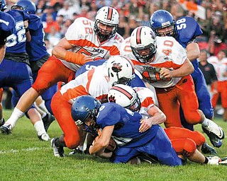 FOOTBALL - The Howland defense (9) Robby Klose (2) Tony Osborne (40) Brandon Miller and (52) Dan Moody stop (30) Ryan Scott for no gain during thier game Thursday night in Cortland. - Special to The Vindicator/Nick Mays