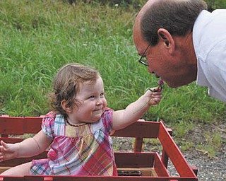 Naomi Lane of Wahalding, Ohio, has Grandpa Dave Dickey of North Lima stopping to smell the flowers!