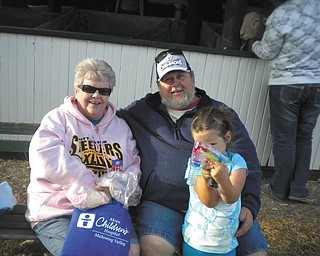 Bob and Sheree Savon of Youngstown are with their grandaughter, Mikayla Upright, at the Canfield Fair.