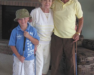 Jonathon Vaschak of Boardman poses with his really awesome grandparents, Joseph and Sylvia Vaschak of Campbell. When Jonathon expressed interest in playing golf with his grandparents, Grammy and Papa gave him a set of clubs for his birthday. Not only does he get to spend time with them, but he has great teachers too! He adores them!