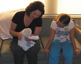 Grandmother Jean DeSocio of Boardman she is showing Natalie Jean her new baby sister, Leah. Both granddaughters are also from Boardman.