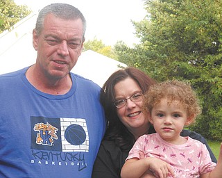 Larry and Melanie Cronk share a moment with their granddaughter, Elizabeth Fisher.