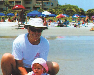 Bill Ogden is pictured with his first grandchild, Carrah, during a visit for the first time to Hilton Head in July.