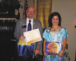 Rotary District Governor W.S. Hays is presented with a certificate by Austintown Rotary President Deanna Spirko for a book donation to Woodside Elementary School library for the Woodside Reads project. Hays visited the club recently and noted Rotary’s impact with the Polio Plus drive, which is helping to eradicate polio across the globe. He noted that last year, only 309 cases were recorded throughout the world.