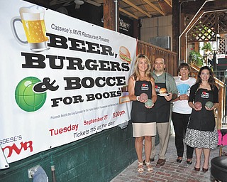 Lindsay Y. McCall | The Vindicator: Joe Cassese of Cassese’s MVR was on hand recently with co-chairwomen, from left, Debbie Liptak, library development director, Julie Costas and Natalie Lariccia to begin planning the Sept. 27 “Beer, Burgers and Bocce for Books, Chapter 11” fundraiser to benefit the Public Library of Youngstown and Mahoning County.