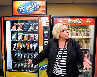 Certified dietary manager Sandy Milan talked about choices available in a vending machine in Kansas City, Missouri, on August 3, 2011. (Keith Myers/Kansas City Star/MCT).r