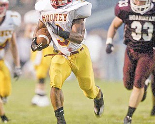 Cardinal Mooney’s Roosevelt Griffin (3) sprints away from Boardman defender Ryan Ebie (33) during Friday’s game in Boardman. The Cardinals got their second win of the season, edging the Spartans, 27-20.