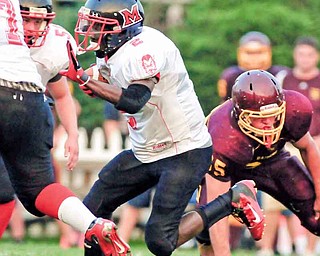 Campbell running back Ja’les Hughes (2) breaks away from South Range defenders for a gain in Friday’s game during Week 2 of the 2011 prep football season at South Range High School in Beaver Township. The Red Devils dominated the Raiders, 41-20.