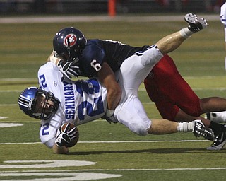 ROBERT K. YOSAY | THE VINDICATOR --..Putttin him down is Fitchs #6 Lucas Haupt puts a stop on #22 Polands Jerry Lawman -..Poland Bulldogs at Fitch Falcons Friday Night Game.--30-..(AP Photo/The Vindicator, Robert K. Yosay)
