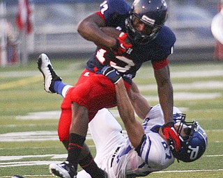 ROBERT K. YOSAY | THE VINDICATOR --..Polands #27 Jordan Smith Takes a stiff arm from Fitchs #13 Will Mahone during first quarter action as Mahone made the first and 10..Poland Bulldogs at Fitch Falcons Friday Night Game.--30-..(AP Photo/The Vindicator, Robert K. Yosay)