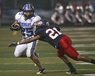 ROBERT K. YOSAY | THE VINDICATOR --..Second quarter action as Polands #25 Mike Turnbull pushes away #21 Will Harrington from Fitch --.Poland Bulldogs at Fitch Falcons Friday Night Game.--30-..(AP Photo/The Vindicator, Robert K. Yosay)