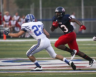 ROBERT K. YOSAY | THE VINDICATOR --..Polands #27 Jordan Smith zeros in on Fitchs #13 Will Mahone during first quarter action as Mahone made the first and 10Poland Bulldogs at Fitch Falcons Friday Night Game.--30-..(AP Photo/The Vindicator, Robert K. Yosay)