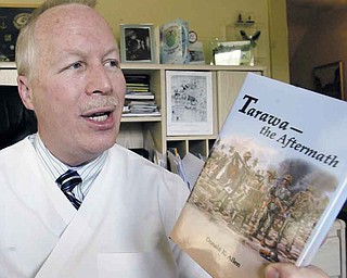 William D Lewis The Vindicator Dr. Don Allen, Boardman veternarian, shows a copy of a book he wrote during a 7-2-11 interview.