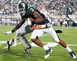 Michigan State's B.J. Cunningham (3) works for extra yardage on a pass reception against Youngstown State's Donald D'Alesio during the third quarter of an NCAA college football game, Friday, Sept. 2, 2011, in East Lansing, Mich. Cunningham caught nine passes for 130 yards and a touchdown. (AP Photo/Al Goldis)