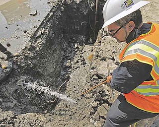 In this Aug. 26, 2011 photo, a city worker repairs a broken water main in Kansas City, Mo. Cities like Kansas City are taking out fewer municipal bonds making budgets tight for all but the most essential repairs. (AP Photo/Charlie Riedel)