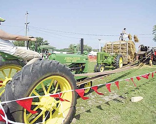 William d Lewis the Vindicator Old fashioned threshing exhibit in the antique farm equipment exhibit at the Canfield Fair Saturday.