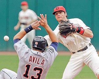 Cleveland Indians second baseman Jason Donald, right, throws over Detroit Tigers' Alex Avila (13) but can't complete a double play on Tigers' Jhonny Peralta in the fourth inning of a baseball game Monday, Sept. 5, 2011, in Cleveland. (AP Photo/Mark Duncan)