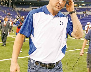 FILE- This Aug. 19, 2011 file photo shows Indianapolis Colts quarterback Peyton Manning walking off the field following an NFL preseason football game against the Washington Redskins in Indianapolis. Manning is doubtful for Sunday's season opener against the Texans as he continues to recover from neck surgery, putting his streak of 227 starts in jeopardy. (AP Photo/Michael Conroy, File)
