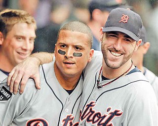 Detroit Tigers starting pitcher Justin Verlander, right, hugs designated hitter Victor Martinez in the dugout after Martinez's grand slam off Cleveland Indians relief pitcher Tony Sipp in the seventh inning of a baseball game Wednesday, Sept. 7, 2011, in Cleveland. (AP Photo/Mark Duncan)