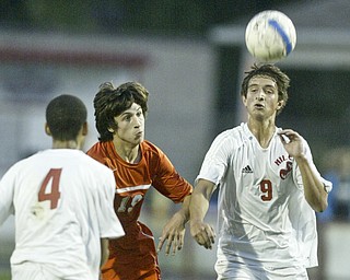 William d Lewis The Vindicator Keir MacMillan of Niles heads the ball while team mate Octavius Smith and Howland's Alex Tvaroch look on during Thursday action at Niles.