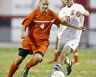 William d Lewis The Vindicator Howland's Kyle Watson, left, and CJ Cicero of Niles go for the ball during Thursday action at Niles.