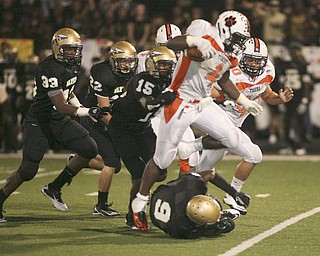 ROBERT K. YOSAY | THE VINDICATOR --..Howlands #4 Deveon Smith hurdles Warrens #9 Lebrandon Watson as he runs for a first down in third quarter action - behind him is Howlands#40 Brandon Miller and Warrens 15-Jal-lyn Moore 22 Kyle Cogley and 33 Audraanez cambridgeHowland Tigers vs Warren G Harding Raiders @ Warren ..--30-..(AP Photo/The Vindicator, Robert K. Yosay)