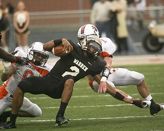ROBERT K. YOSAY | THE VINDICATOR --..Howlands #7 Zach Wilson and #6 Ken Pozega Twists down #2 Warren Jalyn Powell in the backfield of the first quarter action..Howland Tigers vs Warren G Harding Raiders @ Warren ..--30-..(AP Photo/The Vindicator, Robert K. Yosay)