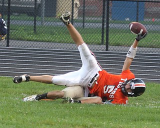 FOOTBALL - (5) Joey Ohlin tries to get the ball into the end zone but is stopped short by (9) Nick Lucente of Lowellville during thier game Friday night in Springfield. - Special to The Vindicator/Nick Mays