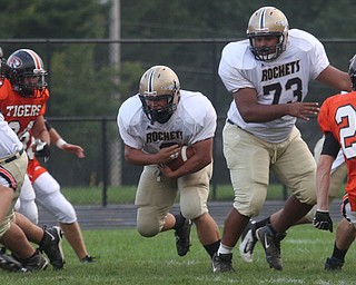 FOOTBALL - Lowellville running back (9) Nick Lucente blasts through a hole behind (73) Will Lightner during thier game Friday night in Springfield. - Special to The Vindicator/Nick Mays