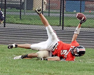 FOOTBALL - (5) Joey Ohlin tries to get the ball into the end zone but is stopped short by (9) Nick Lucente of Lowellville during thier game Friday night in Springfield. - Special to The Vindicator/Nick Mays