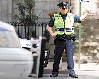 A New York City Police officer directs traffic at a vehicle check point on Friday, Sept. 9, 2011 in New York. The city is deploying additional resources and taking other security steps in response to a potential terror threat before the 10th anniversary of the Sept. 11 attacks. U.S. counterterrorism officials are chasing a credible but unconfirmed al-Qaida threat to use a car bomb on bridges or tunnels in New York or Washington. (AP Photo/Jin Lee)