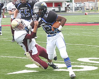 FOOTBALL -(23) Ryan Grier of YCS tries to fight off (82) Tim Cross during thier game Saturday afternoon in Canfield. - Special to The Vindicator/Nick Mays