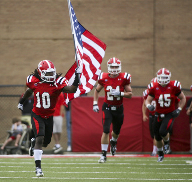 ROBERT K. YOSAY | THE VINDICATOR..YSU #10 Josh Lee carried the US FLAG onto the field as the quins  came onto the field  behind him is #24 Scott Senter.-30