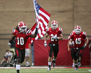 ROBERT K. YOSAY | THE VINDICATOR..YSU #10 Josh Lee carried the US FLAG onto the field as the quins came onto the field behind him is #24 Scott Senter.-30