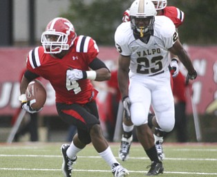 ROBERT K. YOSAY | THE VINDICATOR..Andre Stubbs got the Penguins going with a 50 yard Kick Return he had 118 yards total. Chasing him is #23 John Edwards.-30