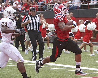 ROBERT K. YOSAY | THE VINDICATOR..YSU Jamaine Cook scampers 31 yards for a TD and pushing the score to 21points as Valpo #23 John Edwards can only watch - Jamaine had 126 yards and 2 TD..-30