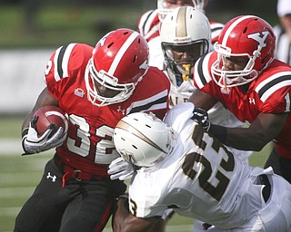 ROBERT K. YOSAY | THE VINDICATOR..Breaking tackles for a first and 10 is #32 Jordan Thompson - #1 YSU Andre Barboza helps block Valpo #23 John Edwards .-30