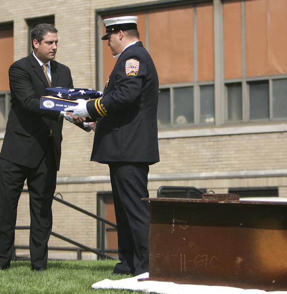 ROBERT  K.  YOSAY  | THE VINDICATOR --..Congrassman Tim Ryan  presents the flag to Bazetta Fire Dept Captain Brian Taylor with the Steel Beam form  WTC..Solemn Service as St Patricks Church in Youngstown, commemerated 9-11 with a prayer, pledge of allegiance, a moment of silence and a flag to Bazetta fire dept by Rep Tim Ryan - the beam from the WTC was then touched by parioshners in a quiet solemn moment..--30-..(AP Photo/The Vindicator, Robert K. Yosay)