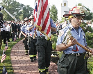 William D. Lewis | The Vindicator Austintown Fire Fighter Honor Guard posts colors during a Sunday observance of the 9/11 attacks at the Austintown 9/11 Memorial Park. Hundreds of area residents and representatives from many fire departments where on hand for the event.