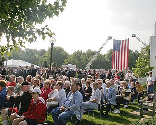 William D. Lewis | The Vindicator A large American Flag was displayed during a Sunday observance of the 9/11 attacks at the Austintown 9/11 Memorial Park. Hundreds of area residents and representatives from many fire departments were on hand for the event.