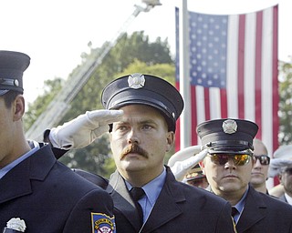 William D. Lewis | The Vindicator Jackson Twp Fire Dept.Randy Wilson Jr. salutes during a Sunday observance of the 9/11 attacks at the Austintown 9/11 Memorial Park. Hundreds of area residents and representatives from many fire departments where on hand for the event.