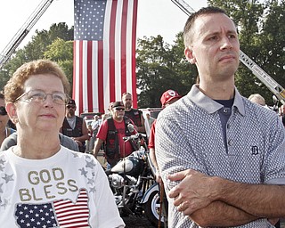 William D. Lewis | The Vindicator Linda Alexander of Austintown and Jeff Mills of Canfield during a Sunday observance of the 9/11 attacks at the Austintown 9/11 Memorial Park. Hundreds of area residents and representatives from many fire departments were on hand for the event.