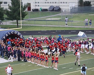 little falcon and little colt football players, fitch cheerleaders & danceline and feddie and freda falcon with the falcons coming out of the tunnel